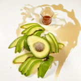 Avocado fruit surrounded by avocado cellular extract