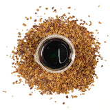 Dried hawthorn berries surround a beaker containing NATIVE EXTRACTS Hawthorn Berries Cellular Extract, deep brown to black in colour