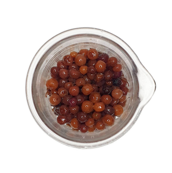A beaker of Native Juniper berries used to create the Native Juniper Cellular Extract.