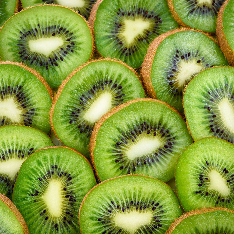 Slices of Kiwi fruits, bright green flesh with a white centre surrounded by rows of small black edible seeds. Scientifically known as Actinidia delicisoa creates NATIVE EXTRACTS Kiwi Fruit Cellular Extract