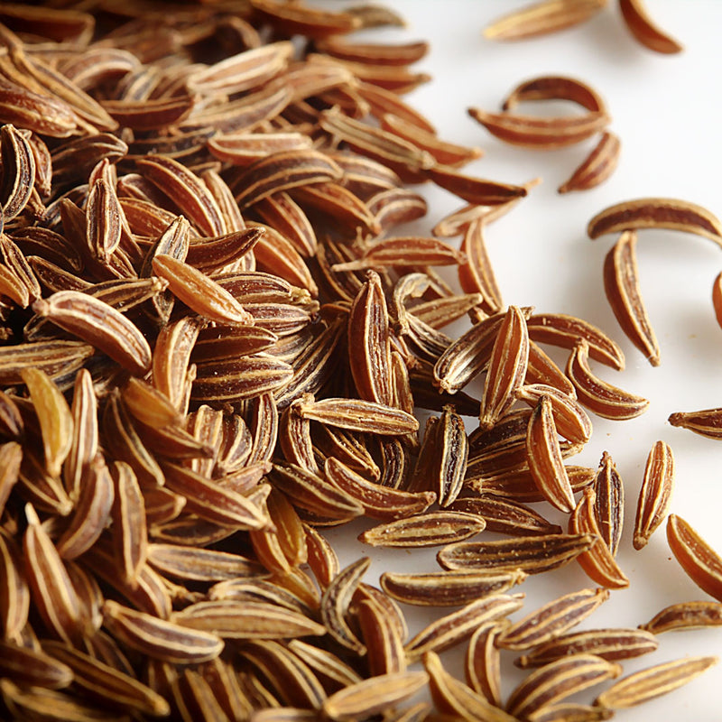 Close up of dried caraway seeds, golden in colour