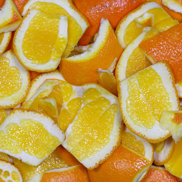 The Orange tree (Citrus aurantium dulcis), has round orange coloured fruit, and is used to create the Native Extracts Orange Cellular Extract. This image shows the fruit cut open, with the dark orange skins and lighter orange flesh.